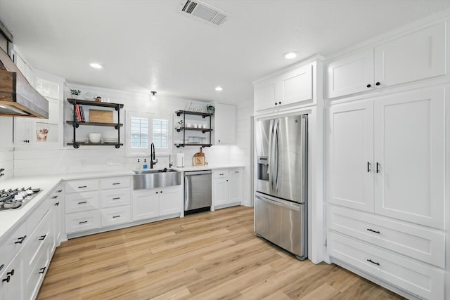 600 Reese Ln, Azle, TX 76020 - kitchen with stainless steel appliances, open shelves, backsplash, white cabinetry, and wall chimney exhaust hood