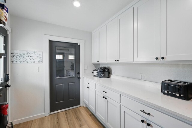 600 Reese Ln, Azle, TX 76020 - kitchen with white cabinets, light countertops, light wood-style flooring, and recessed lighting