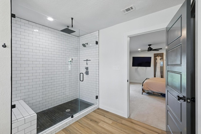 600 Reese Ln, Azle, TX 76020 - full bath featuring connected bathroom, a stall shower, wood finished floors, a textured ceiling, and recessed lighting