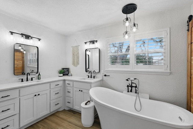 600 Reese Ln, Azle, TX 76020 - full bath featuring wood finished floors, double vanity, and a freestanding tub