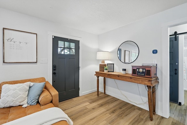 600 Reese Ln, Azle, TX 76020 - entryway featuring a barn door and light wood-style flooring