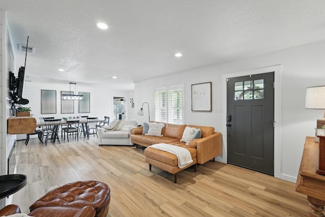 600 Reese Ln, Azle, TX 76020 - living area with light wood-style floors, a textured ceiling, and recessed lighting