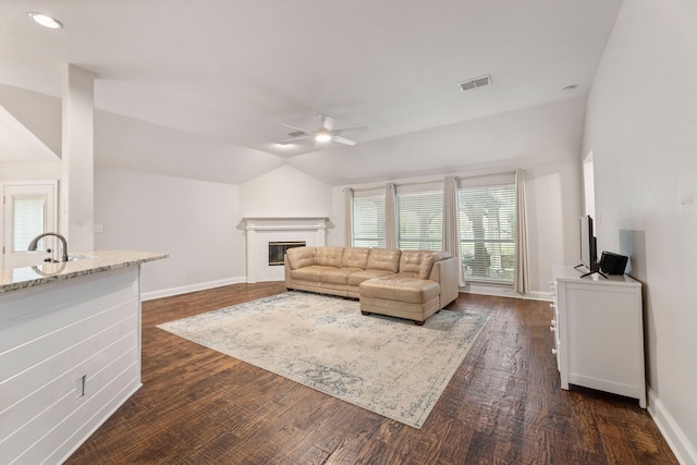 2600 Shiloh Rd, Denton, TX 76210 - living room with ceiling fan, vaulted ceiling, dark wood finished floors, a glass covered fireplace, and recessed lighting