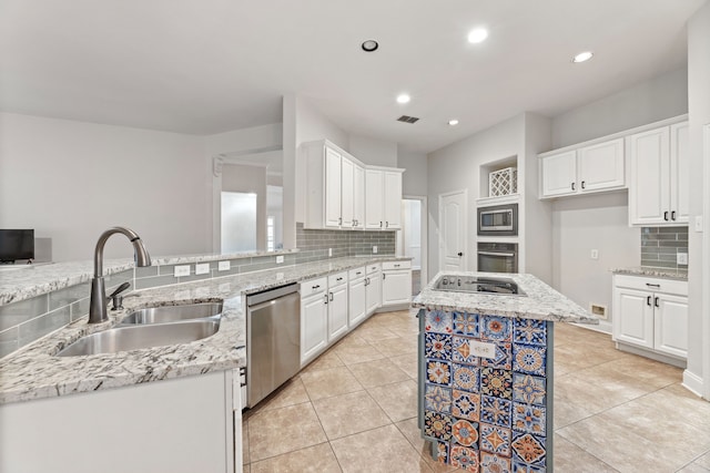 2600 Shiloh Rd, Denton, TX 76210 - kitchen featuring appliances with stainless steel finishes, tasteful backsplash, white cabinets, light stone countertops, and recessed lighting