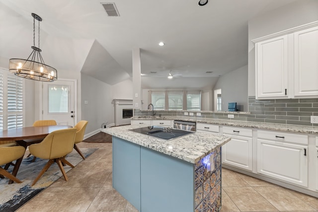 2600 Shiloh Rd, Denton, TX 76210 - kitchen with black electric stovetop, backsplash, a kitchen island, a ceiling fan, and dishwasher