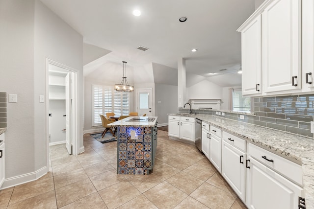 2600 Shiloh Rd, Denton, TX 76210 - kitchen with a chandelier, white cabinets, tasteful backsplash, vaulted ceiling, and light stone countertops