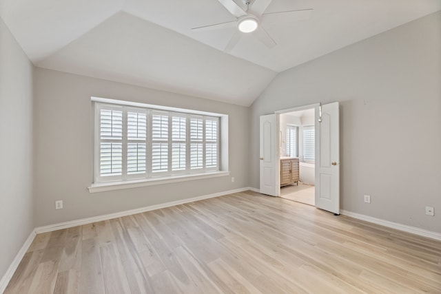 2600 Shiloh Rd, Denton, TX 76210 - unfurnished bedroom featuring multiple windows, light wood finished floors, vaulted ceiling, a ceiling fan, and ensuite bathroom