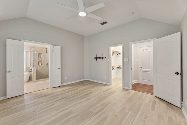 2600 Shiloh Rd, Denton, TX 76210 - unfurnished bedroom with vaulted ceiling, light wood-type flooring, ensuite bathroom, a walk in closet, and a ceiling fan
