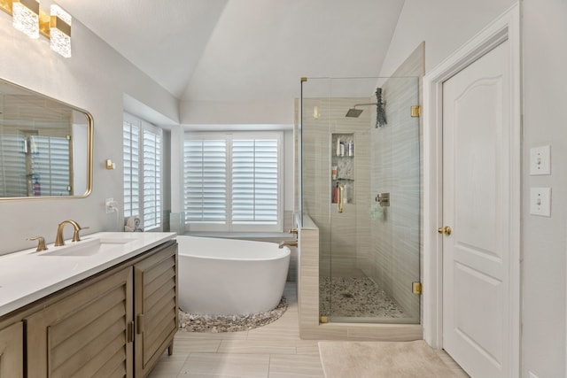 2600 Shiloh Rd, Denton, TX 76210 - bathroom featuring lofted ceiling, a shower stall, a freestanding tub, vanity, and tile patterned floors