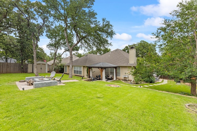 2600 Shiloh Rd, Denton, TX 76210 - rear view of house with an outdoor fire pit, a gazebo, a patio area, a chimney, and a storage shed