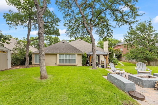2600 Shiloh Rd, Denton, TX 76210 - rear view of house with a fire pit, a gazebo, a chimney, a yard, and roof with shingles