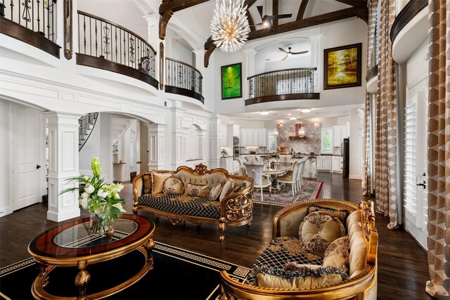 5302 Westfield Dr, Parker, TX 75002 - living area featuring decorative columns, dark wood-style flooring, a towering ceiling, arched walkways, and beamed ceiling
