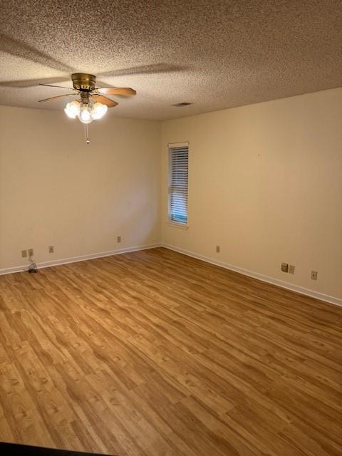 2329 Diana Dr, Sherman, TX 75092 - empty room with wood finished floors, a textured ceiling, and a ceiling fan