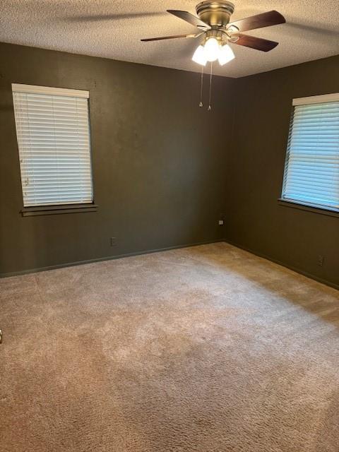 2329 Diana Dr, Sherman, TX 75092 - unfurnished room with a textured ceiling, ceiling fan, and carpet