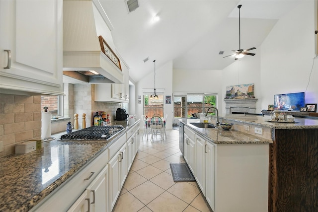 1517 Presley Way, Argyle, TX 76226 - kitchen featuring stainless steel gas stovetop, a fireplace, a ceiling fan, high vaulted ceiling, and open floor plan