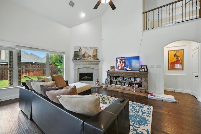 1517 Presley Way, Argyle, TX 76226 - living area with high vaulted ceiling, a ceiling fan, a fireplace with raised hearth, wood finished floors, and arched walkways