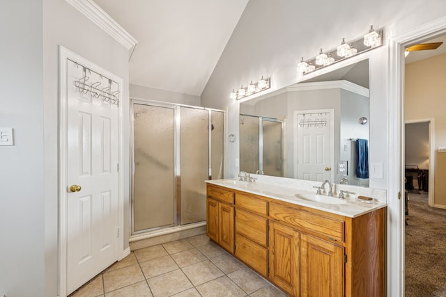 3108 Deerfield Dr, Denton, TX 76208 - full bathroom featuring double vanity, vaulted ceiling, a shower stall, and tile patterned flooring