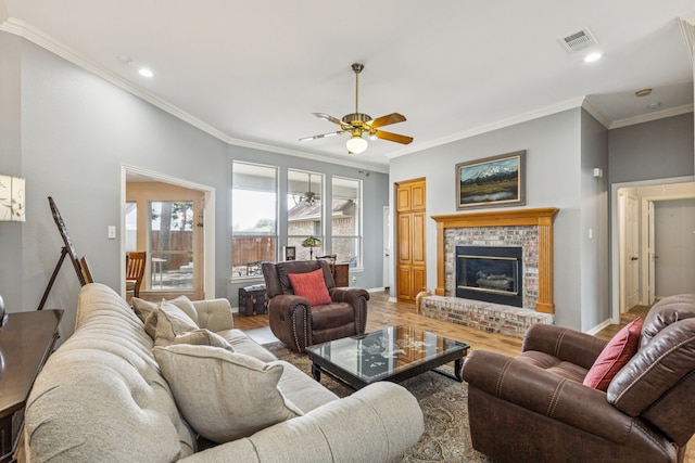 3108 Deerfield Dr, Denton, TX 76208 - living room featuring ceiling fan, crown molding, light wood-style flooring, a brick fireplace, and recessed lighting