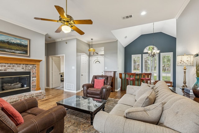 3108 Deerfield Dr, Denton, TX 76208 - living area featuring wood finished floors, a chandelier, ceiling fan, a brick fireplace, and lofted ceiling