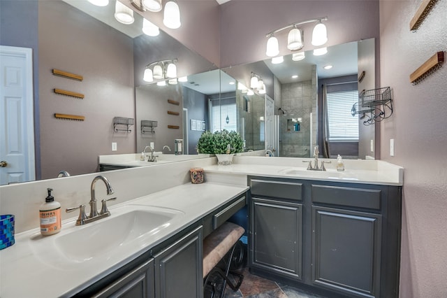 3209 Windridge Ln, Corinth, TX 76208 - bathroom featuring double vanity, a stall shower, healthy amount of natural light, and a textured wall