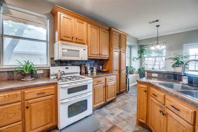 3209 Windridge Ln, Corinth, TX 76208 - kitchen with white appliances, stone finish flooring, backsplash, decorative light fixtures, and ornamental molding