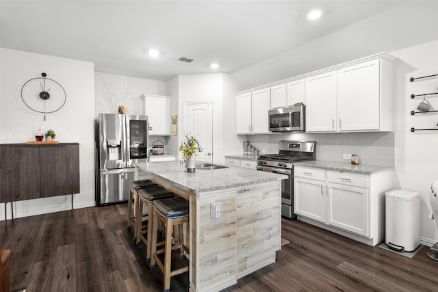 9200 S Field Ln, Arlington, TX 76002 - kitchen with appliances with stainless steel finishes, tasteful backsplash, dark wood-style floors, light stone counters, and recessed lighting