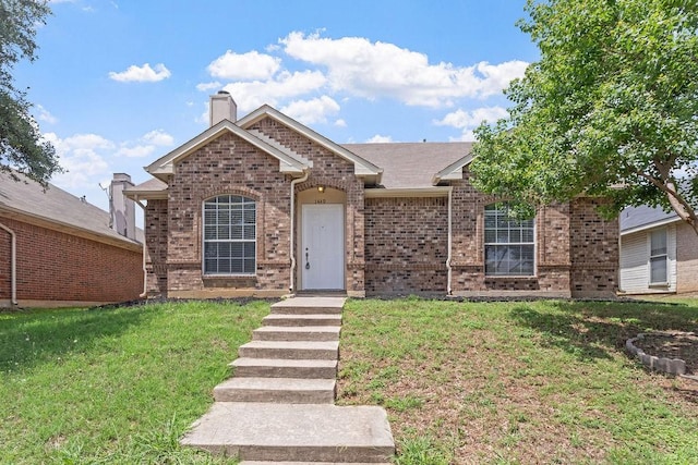 1449 Saint Gallen Ln, Lewisville, TX 75067 - view of front of property featuring a front yard, brick siding, and a chimney