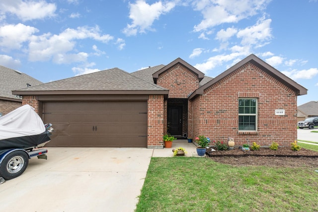 1112 Quaint Mdw, Princeton, TX 75407 - view of front of home with brick siding, an attached garage, a shingled roof, concrete driveway, and a front yard