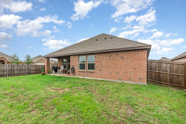 1112 Quaint Mdw, Princeton, TX 75407 - back of property featuring roof with shingles, a fenced backyard, brick siding, and a patio
