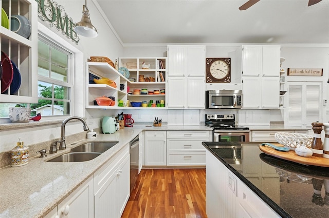 2116 Darby Dan Ct, Granbury, TX 76049 - kitchen with open shelves, appliances with stainless steel finishes, light stone counters, white cabinets, and ornamental molding