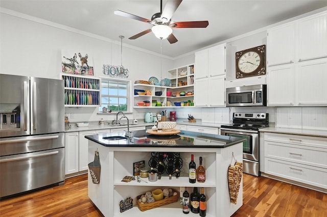 2116 Darby Dan Ct, Granbury, TX 76049 - kitchen with open shelves, appliances with stainless steel finishes, ceiling fan, white cabinetry, and crown molding