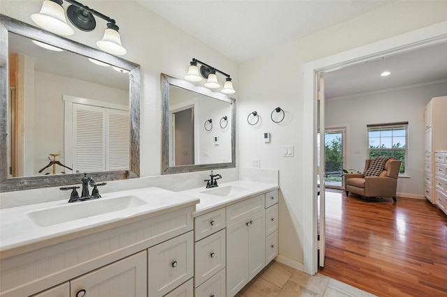 2116 Darby Dan Ct, Granbury, TX 76049 - full bathroom with double vanity, crown molding, and wood finished floors