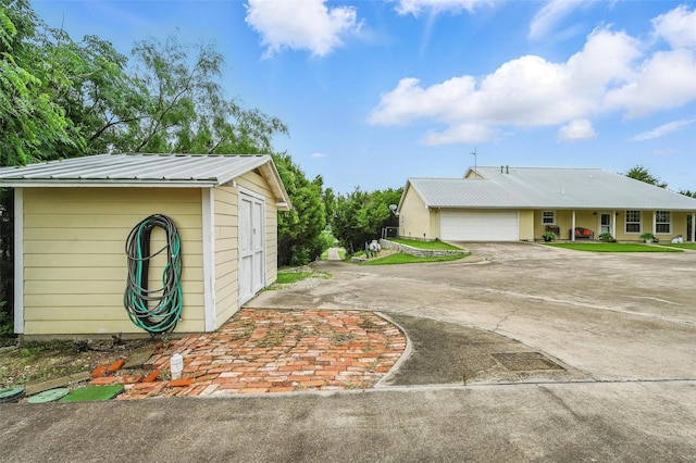 2116 Darby Dan Ct, Granbury, TX 76049 - exterior space with concrete driveway, a metal roof, and a garage