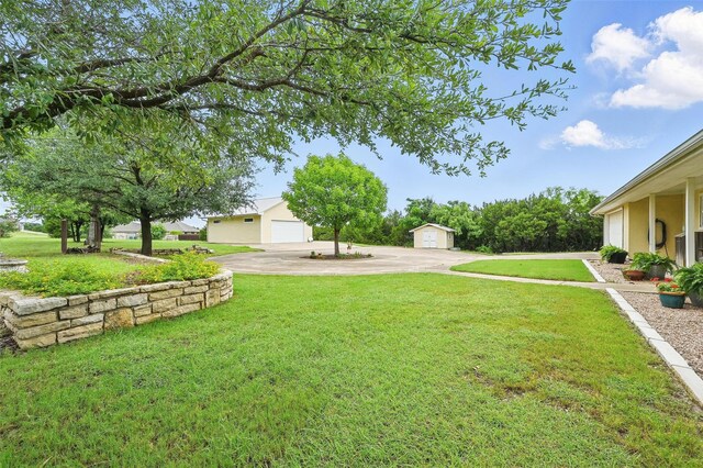 2116 Darby Dan Ct, Granbury, TX 76049 - view of grassy yard with an outdoor structure and a detached garage