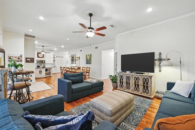 2116 Darby Dan Ct, Granbury, TX 76049 - living room with ceiling fan, recessed lighting, crown molding, and light wood-type flooring