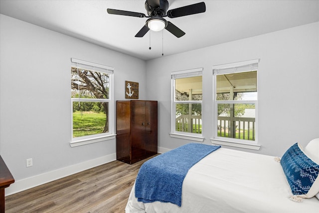 5986 Field Ct, Granbury, TX 76048 - bedroom with wood finished floors and a ceiling fan