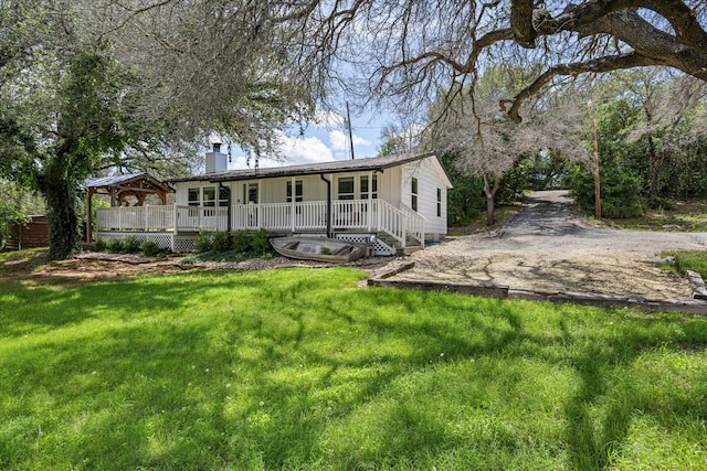 5986 Field Ct, Granbury, TX 76048 - rear view of property featuring a porch, a lawn, and a chimney