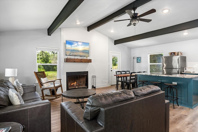 5986 Field Ct, Granbury, TX 76048 - living room featuring light wood-style floors, healthy amount of natural light, recessed lighting, ceiling fan, and a lit fireplace
