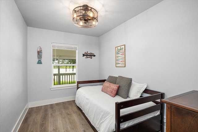 5986 Field Ct, Granbury, TX 76048 - bedroom with wood finished floors and a chandelier