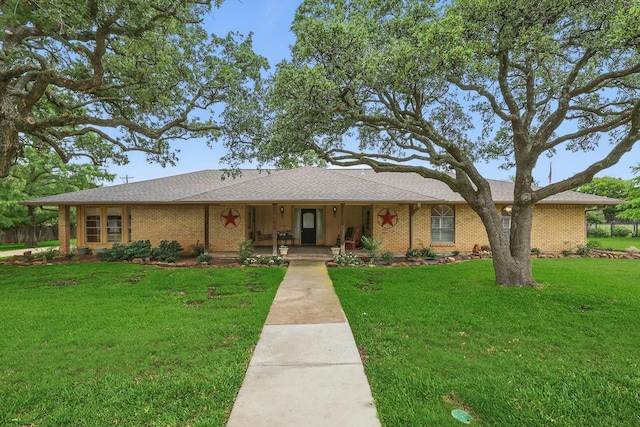 1615 Lopo Rd, Flower Mound, TX 75028 - single story home with brick siding, covered porch, a front lawn, and a shingled roof