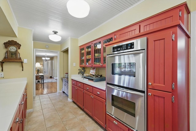 1615 Lopo Rd, Flower Mound, TX 75028 - kitchen featuring stainless steel double oven, light countertops, light tile patterned floors, and glass insert cabinets