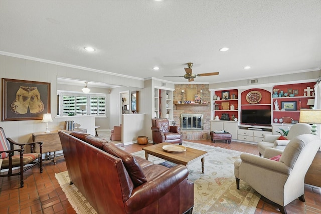 1615 Lopo Rd, Flower Mound, TX 75028 - living area with ornamental molding, ceiling fan, a textured ceiling, recessed lighting, and a fireplace