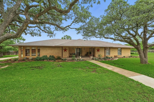 1615 Lopo Rd, Flower Mound, TX 75028 - single story home featuring a front lawn, a porch, and brick siding
