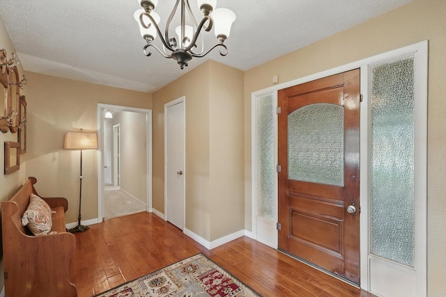 1615 Lopo Rd, Flower Mound, TX 75028 - foyer entrance with wood-type flooring and a chandelier