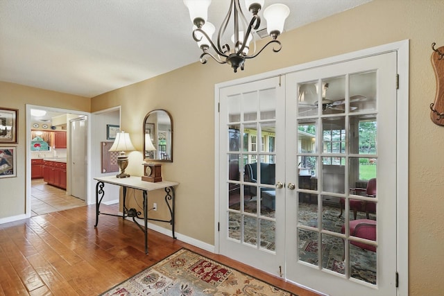 1615 Lopo Rd, Flower Mound, TX 75028 - entryway featuring a chandelier, light wood-type flooring, and french doors