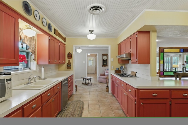 1615 Lopo Rd, Flower Mound, TX 75028 - kitchen featuring appliances with stainless steel finishes, light countertops, light tile patterned floors, backsplash, and crown molding