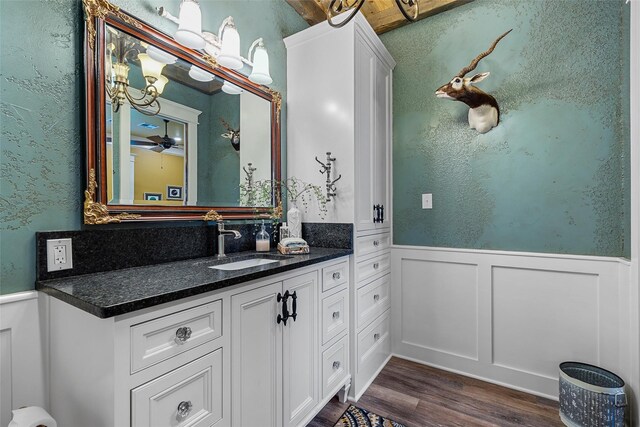 8029 N River Xing, China Spring, TX 76633 - bathroom featuring a wainscoted wall, wood finished floors, vanity, and a textured wall