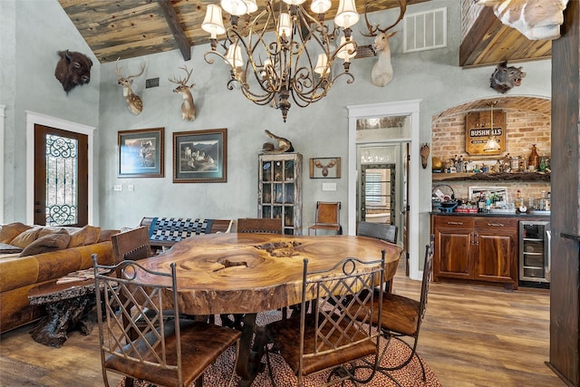 8029 N River Xing, China Spring, TX 76633 - dining area with wine cooler, light wood-style floors, high vaulted ceiling, a wooden ceiling with exposed beams, and bar
