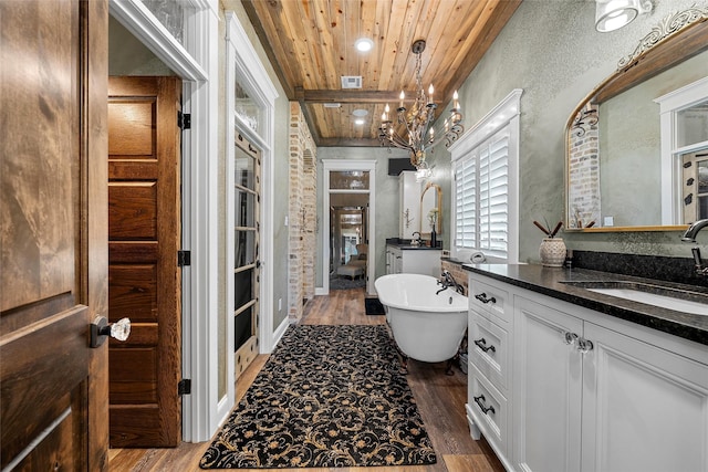 8029 N River Xing, China Spring, TX 76633 - bathroom featuring wooden ceiling, wood finished floors, vanity, a freestanding tub, and a chandelier