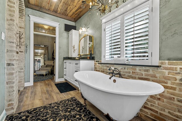 8029 N River Xing, China Spring, TX 76633 - full bathroom featuring wooden ceiling, a soaking tub, vanity, wood finished floors, and a chandelier